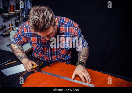 Leather Artist creating new leatherwork Stock Photo