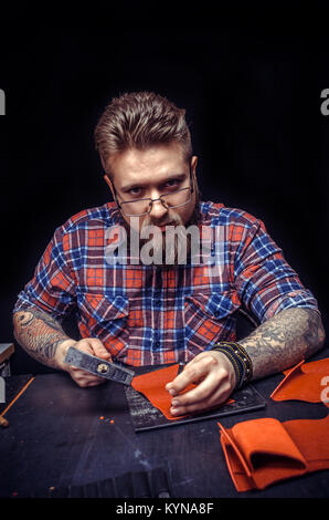 Professional Tanner being keen on his buisness in his studio Stock Photo