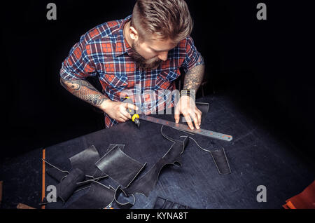 Professional Leather Worker producing leather workpiece Stock Photo