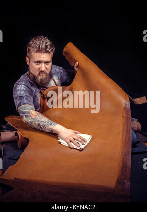 Leather Professional forming new leather production at his workshelf Stock Photo