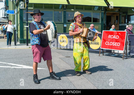 Broadstairs Folk Week Festival. Allsorts Morris side dancing on the seafront on the promenade in the sunshine. Stock Photo