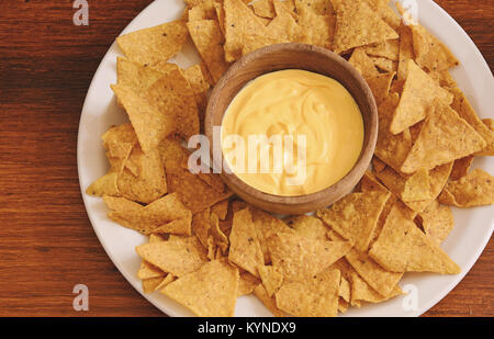 Top view of nachos with cheese dip. Unhealthy food concept Stock Photo