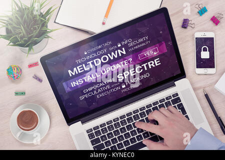 Installing update against meltdown and spectre threat concept on top view laptop screen. Stock Photo