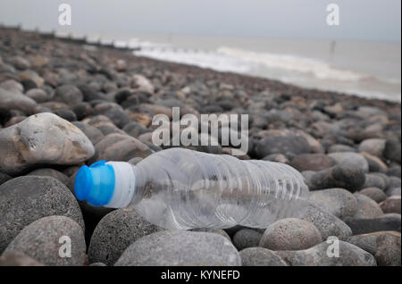 plastic water bottle washed up on shingle beach, sheringham, north norfolk, england Stock Photo