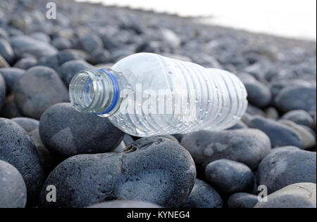 plastic water bottle washed up on shingle beach, sheringham, north norfolk, england Stock Photo