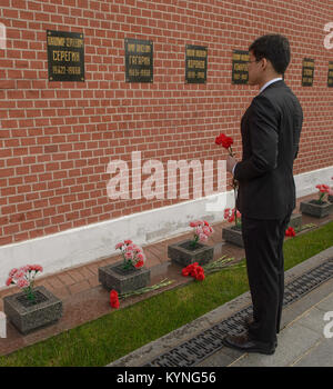 Expedition 52 backup crew member Norishige Kanai of JAXA participates in a pre-launch ceremony in Moscow, honoring Russian space pioneers by laying roses at the site of their burial. Stock Photo
