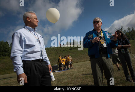 NASA Acting Chief Technologist Douglas Terrier, left, and Greg “Box” Johnson, executive director of Center for the Advancement of Science in Space (CASIS) and former astronaut, right, watch as attendees of the Boy Scouts of America National Jamboree prepare to launch a weather balloon, Tuesday, July 25, 2017 at the Summit Bechtel Reserve in Glen Jean, West Virginia. Photo Credit: (NASA/Bill Ingalls) Stock Photo