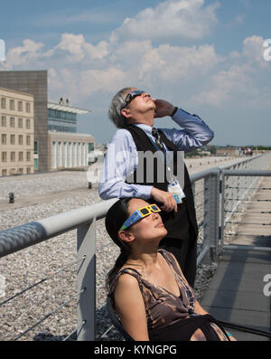 On August 21, 2017, NASA employees at Headquarters in Washington, D.C. used protective glasses to view a partial solar eclipse visible across North America, as part of the broader total solar eclipse seen in the U.S. Stock Photo
