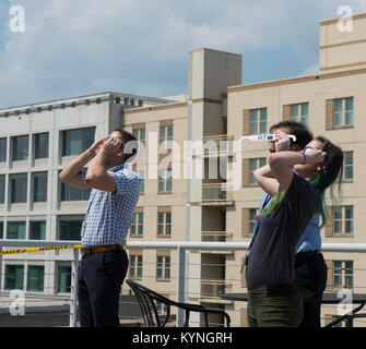 NASA employees and contractors observed a partial solar eclipse from NASA Headquarters in Washington on August 22, 2017, using protective glasses for safety. Stock Photo