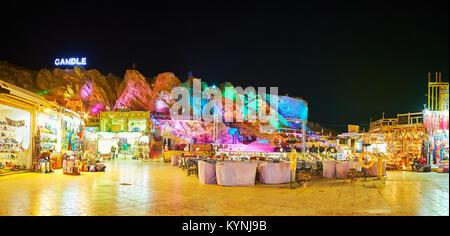 SHARM EL SHEIKH, EGYPT- DECEMBER 15, 2017: The restaurant court in Old Souk of resort, outdoor cafes are surrounded by tourist stalls, the rocks, illu Stock Photo