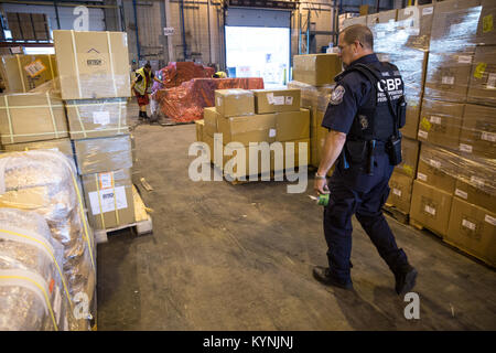 Officers with the U.S. Customs and Border Protection, Office of Field Operations, inspect shipments at a cargo facility at Boston Logan International Airport for contraband June 20, 2017 in Boston, Mass. U.S. Customs and Border Protection photo by Glenn Fawcett Stock Photo