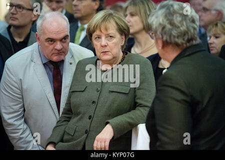 Trinwillershagen, Germany. 12th Jan, 2018. German Chancellor Angela Merkel (CDU) speaks with the mayor of Zingst, Andreas Kuhn (CDU) during the New Year's Reception of the state counsil of the district Vorpommern-Ruegen in Trinwillershagen, Germany, 12 January 2018. Merkel has been representing the electoral district Stralsund-Greifswald-Ruegen-Vorpommern since 1990 in the German Bundestag with a direct mandate. Credit: Stefan Sauer/dpa/Alamy Live News Stock Photo
