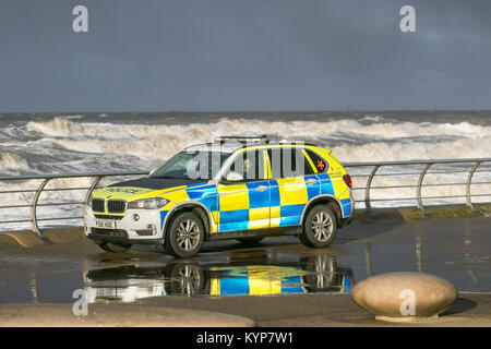 Blackpool Lancashire. 16th Jan 2018. UK Weather. Gale Force Winds in Blackpool. An amber 'be prepared' warning, which includes winds gusting up to 50mph in some areas, has been issued for the northwest coasts of England. Armed response vehicle (ARV) is a type of BMW police car operated by British law enforcement, policing vehicle, armed, protection, weapon, man, people, security, gun, car, street, force, officers.  ARVs Police cars are crewed by Authorised Firearms Officers to respond to incidents believed to involve firearms or other high-risk situations. Stock Photo