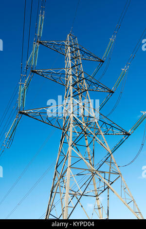 Electricity pylon against blue sky shot from below, England, UK Stock Photo
