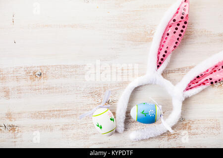 Easter eggs on wooden background . Easter still life with rabbit ears and eggs Stock Photo