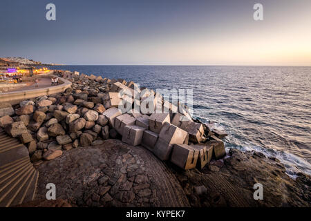 Breakwater blocks in the port of Puerto Rico, Gran Canaria, with the Atlantic Ocean in the background Stock Photo