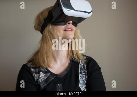Woman using VR headset Stock Photo
