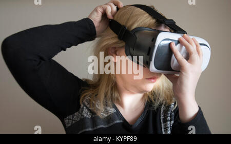 Woman using VR headset Stock Photo