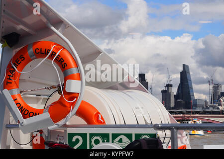 View across to the City of London from the front of a passenger cruiser boat on the river Thames Stock Photo