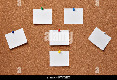 close up of note papers with pushpins on a corkboard Stock Photo