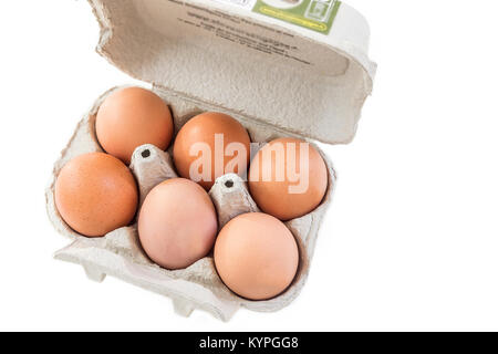 Close up shot of an open recyclable egg carton with six eggs inside on a white background Ecological healthy food from bio farms. Stock Photo