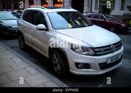 White Volkswagen Tiguan 2.0 with a parking ticket Penalty Charge Notice attached to the windscreen Stock Photo