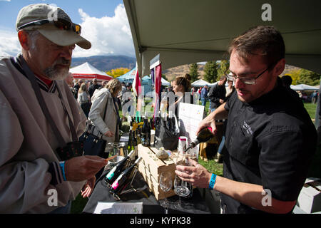 Visting attendees tasting the various wines that are on display at the annual Festival of the Grape located in Oliver, British Columbia, Canada. Stock Photo