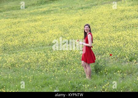 Tuscany tourist - pretty woman in red dress visits Tuscan countryside in Siena province, Italy. Stock Photo