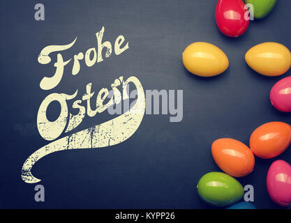 Colorful plastic Easter eggs on a chalkboard with space for text or image Stock Photo