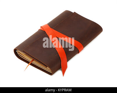 Close up of one vintage style jotter notebook with old leather cover and orange bookmark strap, isolated on white, elevated high angle view Stock Photo