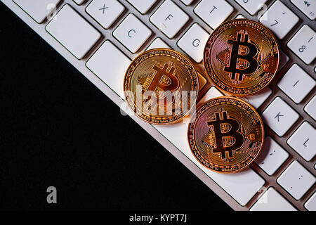 Bitcoins on computer keyboard, virtual BTC cryptocurrency concept Stock Photo