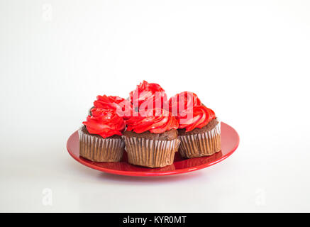 6 kosher chocolate cupcakes with red frosting on a red plate isolated on white for Valentine's Day Stock Photo