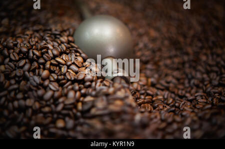 Freshly roasted coffee beans in roasting machine Stock Photo