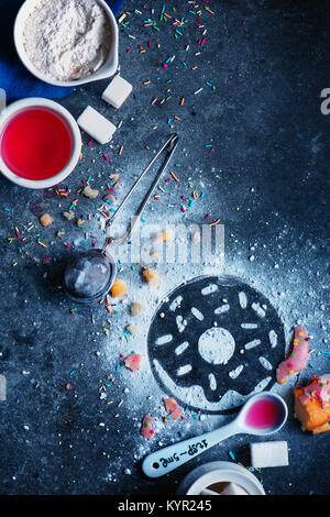 Silhouette of a donut made with sugar powder. Cooking flat lay with flour, glazing, sugar and sprinkles. Baking photography concept. Stock Photo