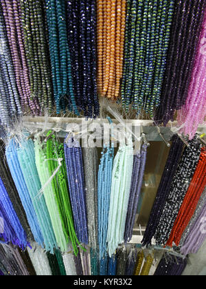 many necklaces with beads on sale in the shop Stock Photo