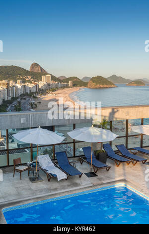 Luxurious aerial view of Copacabana beach from a rooftop swimming pool lounge area - concept of literally living the 'high life' Stock Photo