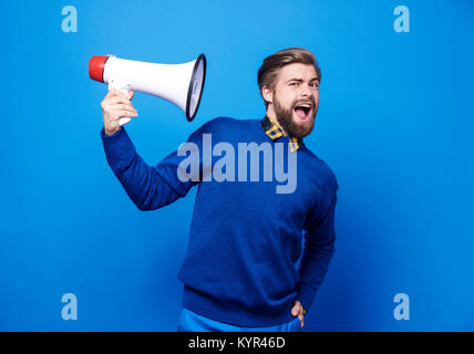 Portrait of man holding a megaphone Stock Photo