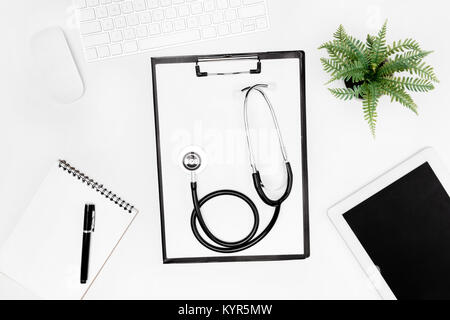 flat lay with stethoscope, clipboard, empty notebook and digital devices isolated on white