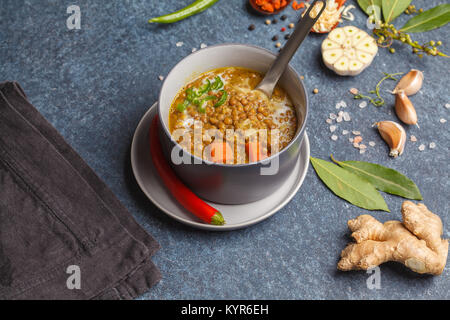 Indian vegetarian lentil soup, mung dal. Indian food spice concept. Dark background, top view. Stock Photo