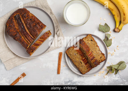 Sliced banana bread with cinnamon in gray plates. Gray background. Vegan Healthy Food Concept. Top view. Stock Photo