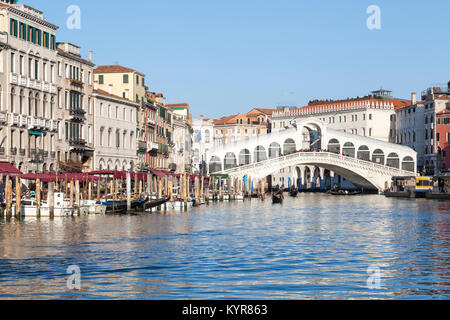 Gondolas under the Rialto Bridge, San Polo, Grand Canal, Venice,  Veneto, Italy on a sunny winter day Stock Photo