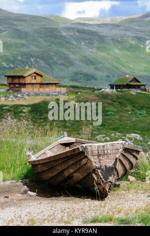 Wooden boat and traditional timber houses with sod roofs in Sogn og Fjordane county in western Norway Stock Photo