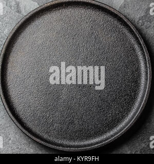 Food background. Empty cast iron black plate. Copy space Stock Photo