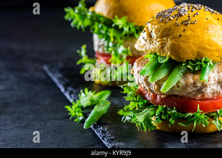 Colored yellow burgers. Homemade American chicken burgers hamburgers ...