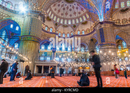 Muslim People praying in Blue Mosque also called Sultan Ahmed Mosque or Sultan Ahmet Mosque.ISTANBUL,TURKEY- MARCH 11, 2017 Stock Photo