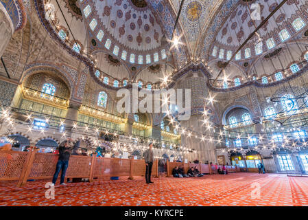 Muslim People praying in Blue Mosque also called Sultan Ahmed Mosque or Sultan Ahmet Mosque.ISTANBUL,TURKEY- MARCH 11, 2017 Stock Photo