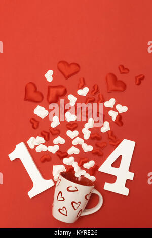 An explosion of hearts out of a tea cup and the number 14 made with wood numbers: valentine's day concept Stock Photo