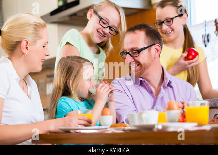 Family at home having breakfast in kitchen Stock Photo