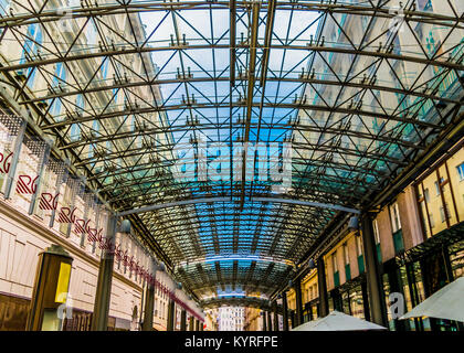 Modern architecture detail, steel and glass ceiling. Patterned glass ceiling covers gallery between older buildings. Stock Photo