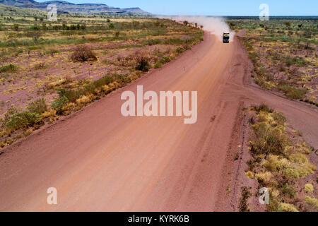 Road train truck travelling on a red dusty road in the Australian outback, Pilbara, Western Australia Stock Photo